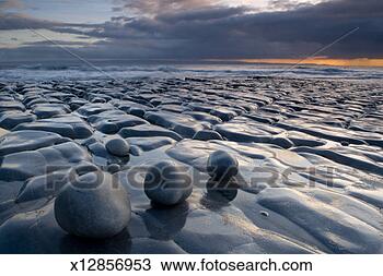 Stock Photo - wales, glamorgan, 
monknash, rock 
formations by 
sea, sunset. fotosearch 
- search stock 
photos, pictures, 
images, and photo 
clipart