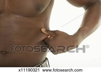 Stock Photography - young man pinching 
skin on abdomen, 
mid-section, close-up. 
fotosearch - search 
stock photos, 
pictures, images, 
and photo clipart