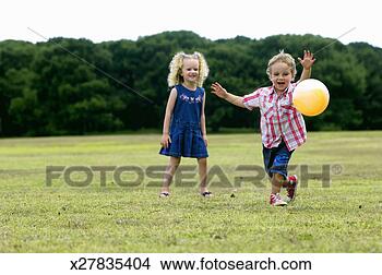 Stock Photo - girl (3-5) and 
boy (2-4) playing 
with ball in park, 
boy chasing ball. 
fotosearch - search 
stock photos, 
pictures, images, 
and photo clipart