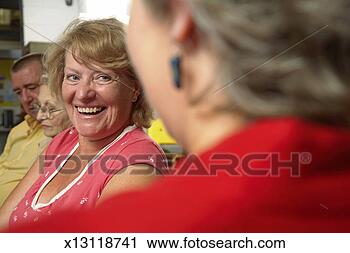 Stock Photography - mature man and 
women, mature 
woman smiling 
at another woman, 
close-up. fotosearch 
- search stock 
photos, pictures, 
images, and photo 
clipart