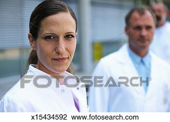 Stock Photo - group of doctors 
outdoors, focus 
on female doctor, 
portrait. fotosearch 
- search stock 
photos, pictures, 
images, and photo 
clipart