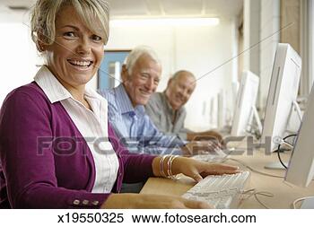 Stock Image - mature woman and 
two mature men 
in computing class, 
portrait. fotosearch 
- search stock 
photos, pictures, 
images, and photo 
clipart
