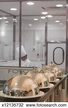 Stock Photo - food covered with 
lids on counter 
in hotel kitchen. 
fotosearch - search 
stock photos, 
pictures, images, 
and photo clipart
