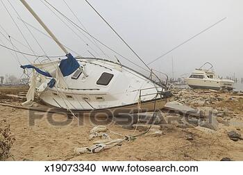Stock Photography - overturned sailboat 
in wake of hurricane 
ivan in pensacola 
florida. fotosearch 
- search stock 
photos, pictures, 
images, and photo 
clipart
