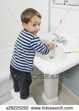 Stock Photography - young boy (4-5) 
washing hands 
in bathroom sink. 
fotosearch - search 
stock photos, 
pictures, images, 
and photo clipart