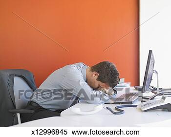 Stock Image - business man leaning 
head on desk in 
office. fotosearch 
- search stock 
photos, pictures, 
images, and photo 
clipart
