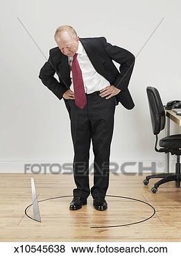 Stock Photo - businessman looking 
at saw cutting 
floor around it. 
fotosearch - search 
stock photos, 
pictures, images, 
and photo clipart