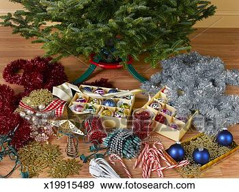 Stock Photograph - christmas ornaments 
on floor next 
to christmas tree. 
fotosearch - search 
stock photos, 
pictures, images, 
and photo clipart