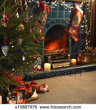 Stock Photo - christmas presents 
under tree, in 
front of decorated 
fire place. fotosearch 
- search stock 
photos, pictures, 
images, and photo 
clipart
