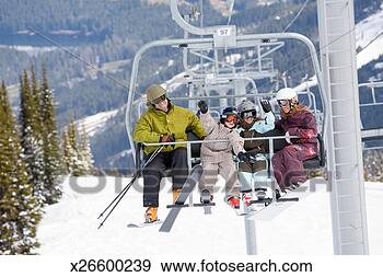 Stock Photograph - family with two 
kids (6-7) on 
chairlift with 
skis. fotosearch 
- search stock 
photos, pictures, 
images, and photo 
clipart
