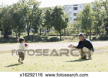 Stock Photo - father playing 
with baby boy 
(18-24 months) 
in park, side 
view. fotosearch 
- search stock 
photos, pictures, 
images, and photo 
clipart