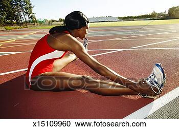 Stock Photography - female athlete 
stretching on 
track. fotosearch 
- search stock 
photos, pictures, 
images, and photo 
clipart