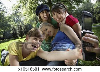 Stock Photography - group of friends 
(14-19) taking 
self-photo with 
mobile phone in 
park. fotosearch 
- search stock 
photos, pictures, 
images, and photo 
clipart