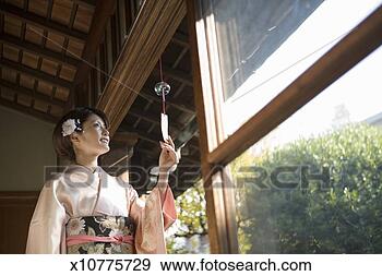 Stock Photograph - japan, tokyo, 
woman in kimono 
touching japanese 
wind chime. fotosearch 
- search stock 
photos, pictures, 
images, and photo 
clipart