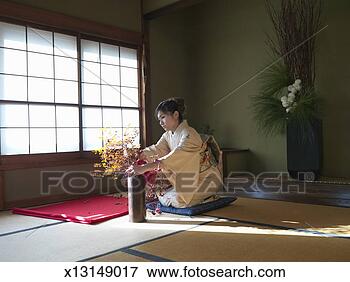 Picture - japan, tokyo, 
woman wearing 
kimono arranging 
flowers. fotosearch 
- search stock 
photos, pictures, 
images, and photo 
clipart