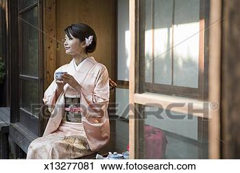 Stock Photography - japan, tokyo, 
woman in kimono 
drinking tea. 
fotosearch - search 
stock photos, 
pictures, images, 
and photo clipart