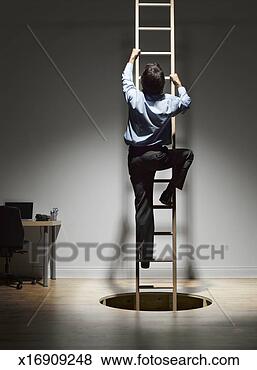 Stock Photo - man climbing on 
ladder coming 
through hole in 
wooden floor, 
rear view. fotosearch 
- search stock 
photos, pictures, 
images, and photo 
clipart