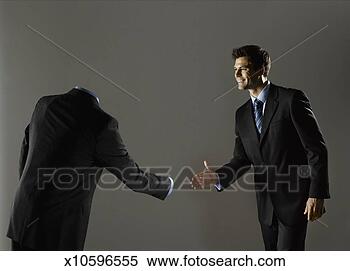 Stock Image - man shaking hands 
with mannequin, 
smiling. fotosearch 
- search stock 
photos, pictures, 
images, and photo 
clipart