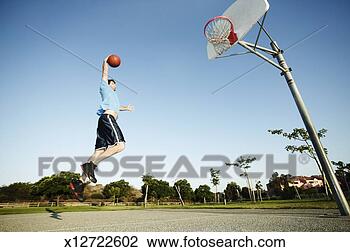 Stock Photo - man slamdunking 
basketball on 
outdoor court. 
fotosearch - search 
stock photos, 
pictures, images, 
and photo clipart
