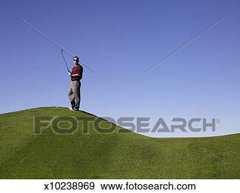 Stock Photograph - man standing on 
hill at golf course. 
fotosearch - search 
stock photos, 
pictures, images, 
and photo clipart