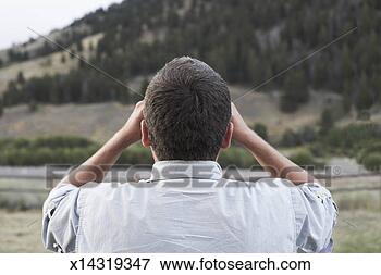 Picture - mature man looking 
through binoculars, 
rear view. fotosearch 
- search stock 
photos, pictures, 
images, and photo 
clipart