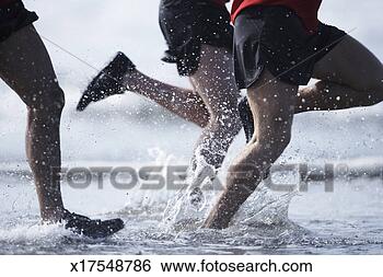 Stock Photo - men running in 
ocean, low section. 
fotosearch - search 
stock photos, 
pictures, images, 
and photo clipart