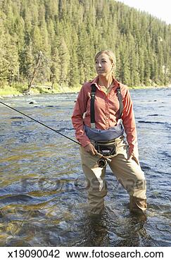 Stock Photo - mid adult woman 
with fishing rod 
in middle of river. 
fotosearch - search 
stock photos, 
pictures, images, 
and photo clipart