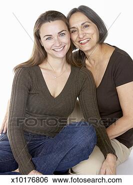 Stock Photo - mother and adult 
daughter cheek 
to cheek, portrait, 
studio shot. fotosearch 
- search stock 
photos, pictures, 
images, and photo 
clipart