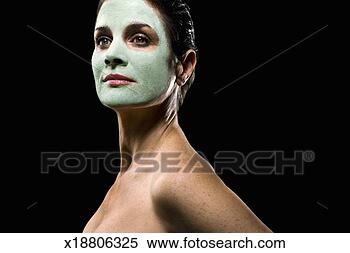 Stock Image - naked mature woman 
wearing facial 
mask,  posing 
against black. 
fotosearch - search 
stock photos, 
pictures, images, 
and photo clipart