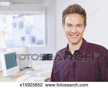 Stock Photo - office worker 
in office, portrait. 
fotosearch - search 
stock photos, 
pictures, images, 
and photo clipart