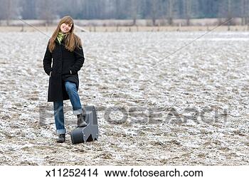 Stock Photo - portrait of mid 
adult woman with 
guitar case in 
fields. fotosearch 
- search stock 
photos, pictures, 
images, and photo 
clipart