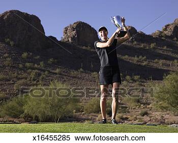 Stock Image - portrait of mid 
adult woman holding 
golf trophy on 
golf course. fotosearch 
- search stock 
photos, pictures, 
images, and photo 
clipart