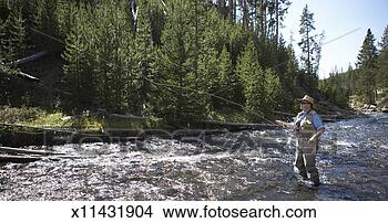 Stock Photo - senior man flyfishing 
in river. fotosearch 
- search stock 
photos, pictures, 
images, and photo 
clipart