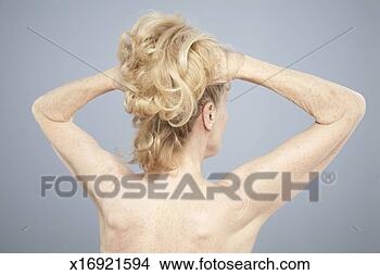 Stock Photo - senior woman holding 
up hair, rear 
view. fotosearch 
- search stock 
photos, pictures, 
images, and photo 
clipart