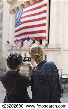 Stock Photography - two businesswomen 
photographing 
new york stock 
exchange, rear 
view. fotosearch 
- search stock 
photos, pictures, 
images, and photo 
clipart