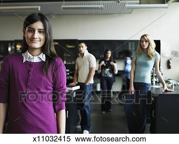 Stock Image - young female student 
(15-17) standing 
in front of classmates 
in. fotosearch 
- search stock 
photos, pictures, 
images, and photo 
clipart