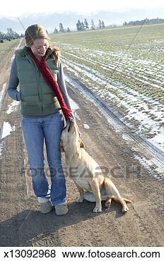 Stock Photo - young woman on 
dirt road with 
labrador dog. 
fotosearch - search 
stock photos, 
pictures, images, 
and photo clipart