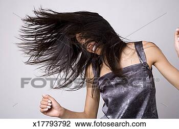 Stock Photo - young woman flicking 
hair, smiling. 
fotosearch - search 
stock photos, 
pictures, images, 
and photo clipart