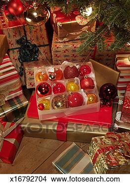 Stock Photo - christmas baubles 
among presents 
underneath christmas 
tree. fotosearch 
- search stock 
photos, pictures, 
images, and photo 
clipart