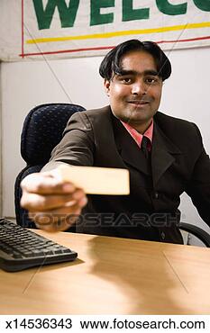 Stock Photo - business man offering 
business card 
in office. fotosearch 
- search stock 
photos, pictures, 
images, and photo 
clipart