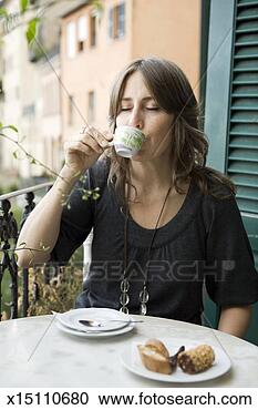 Stock Photography - mid adult woman 
having espresso 
at balcony. fotosearch 
- search stock 
photos, pictures, 
images, and photo 
clipart
