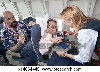 Stock Photo - air stewardess 
gives preferential 
treatment to a 
male passenger. 
fotosearch - search 
stock photos, 
pictures, images, 
and photo clipart