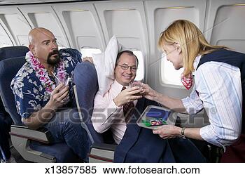 Stock Image - comfortable businessman 
in an aeroplane 
cabin interior 
receiving a. fotosearch 
- search stock 
photos, pictures, 
images, and photo 
clipart
