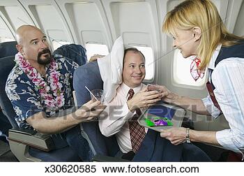 Stock Image - comfortable businessman 
in an aeroplane 
cabin interior 
receiving a. fotosearch 
- search stock 
photos, pictures, 
images, and photo 
clipart