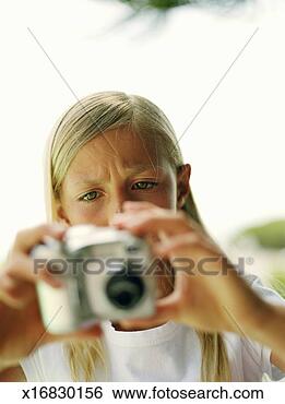 Stock Photo - girl (8-10) looking 
at digital camera, 
close-up (focus 
on girl). fotosearch 
- search stock 
photos, pictures, 
images, and photo 
clipart