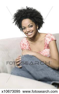 Stock Image - medium shot of 
a young adult 
woman in a floral 
shirt as she sits 
on a. fotosearch 
- search stock 
photos, pictures, 
images, and photo 
clipart