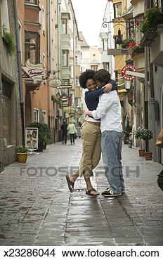 Stock Photo - wide shot of a 
young adult couple 
as they lovingly 
embrace in a. 
fotosearch - search 
stock photos, 
pictures, images, 
and photo clipart