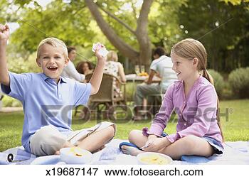 Picture - young boy and 
girl sit in their 
garden playing 
cards,  the boy. 
fotosearch - search 
stock photos, 
pictures, images, 
and photo clipart
