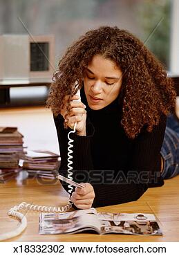 Stock Photo - young woman making 
a credit card 
purchase over 
the phone. fotosearch 
- search stock 
photos, pictures, 
images, and photo 
clipart