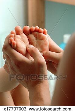 Stock Photo - baby girl (12-18 
months) with feet 
in air, mother 
holding feet. 
fotosearch - search 
stock photos, 
pictures, images, 
and photo clipart